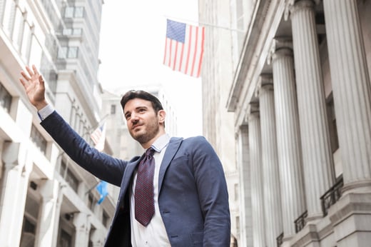 smiling-businessman-hailing-cab (1)